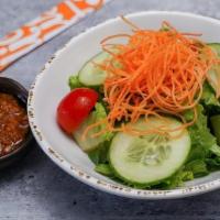 Side Salad · Mixed greens, tomatoes, carrots, cucumbers & ginger-carrot dressing