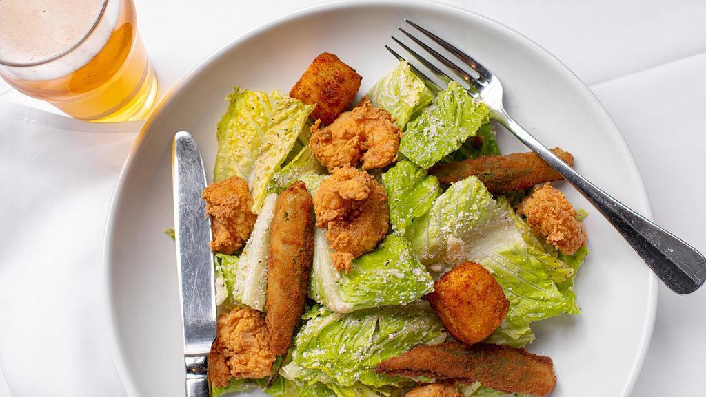 Caesar Salad · Romaine hearts, crispy okra, garlic grit croutons, and Grana Padano. Consuming raw or undercooked meats, poultry, seafood, shellfish or eggs may increase your risk of foodborne illness.