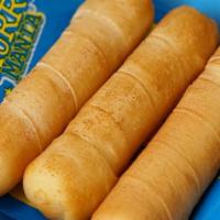 Tequeños Jumbo · Cheese filled sticks and wrapped in sheet of dough. 4 pc.