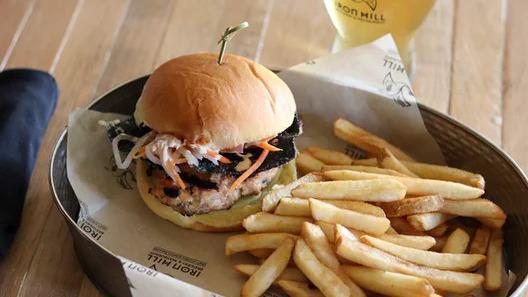 Asian Salmon Burger · fried nori, pickled vegetables, cucumber, pickled. ginger, wasabi soy mayonnaise, potato roll
