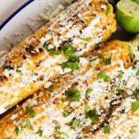 Street Corn (Elote) · Fresh Grilled Corn on the cob, topped with our special sauce and cotija cheese