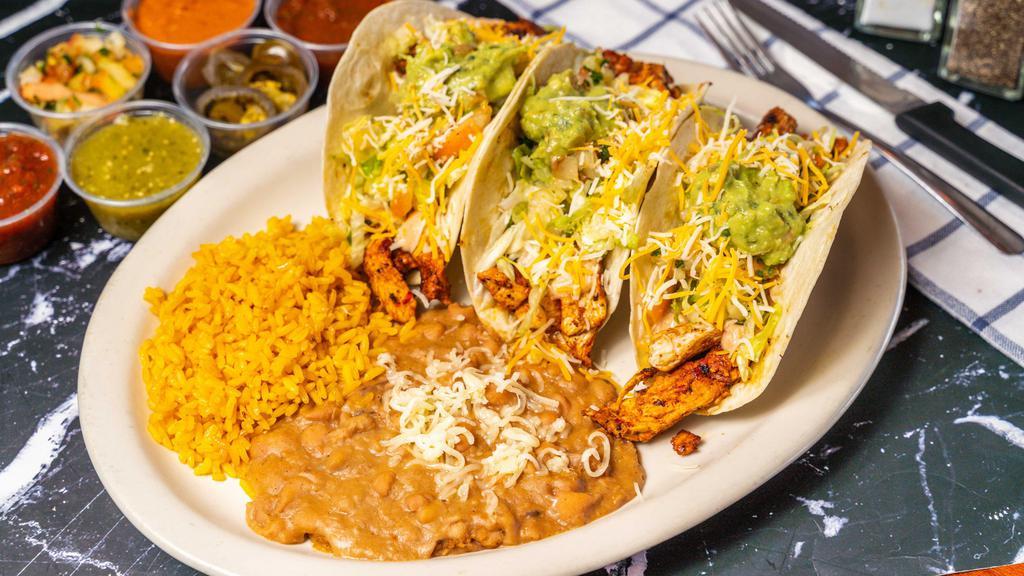 Loaded Tacos · 3 tacos. Topped with lettuce, pico de gallo, guacamole, cheese, and Chipotle cream. Served with rice and beans on the side.