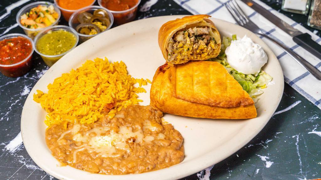 Chimichanga · Large fried burrito, filled with rice, pico de gallo, cheese, and cream sauce. Your choice of chicken, beef, pork or beans.  Served with rice and beans on the side.