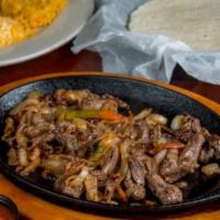 Steak Fajita · Served with tortillas, rice and beans, guacamole, sour cream, and cheese.