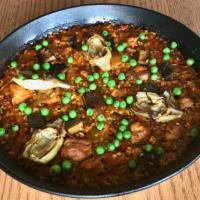 Fam Chicken Paella · Valencia style rice, chicken, artichoke hearts, Cremini mushrooms, green peas, red sofrito, ...