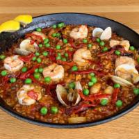 Fam Paella Mixta · Valencia style rice, calamari, clams, shrimp, chorizo, chicken, sofrito de calamar, saffron....