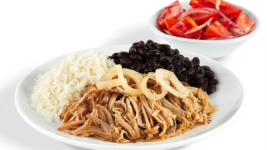 Mojo Roast Pork - With Rice And Beans And 1 Additional Side · Slow roasted in a mojo juice blend, our pork is a moist and tender marvel crowned with sautéed onions.
