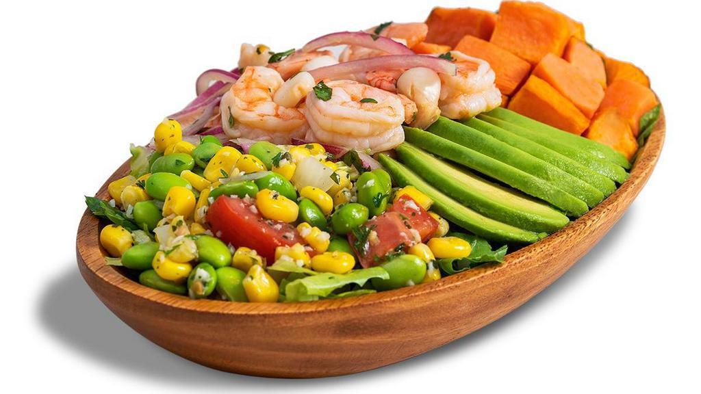 Shrimp Ceviche Bowl · Why have one taste of summer when you can have them all! Enjoy our crisp and cold signature bowl made with our fresh shrimp ceviche featuring chocolo corn, red onions, aji amarillo, and cilantro, paired with tasty sweet potato, avocado slices, and succotash, all over a bed of lettuce. It’s all made in house – so tasty it will put a sunny smile on your face!