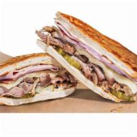 Cuban Sandwich · Mojo Roast Pork and sliced ham together on a Cuban roll with Gouda cheese, pickles and a cre...