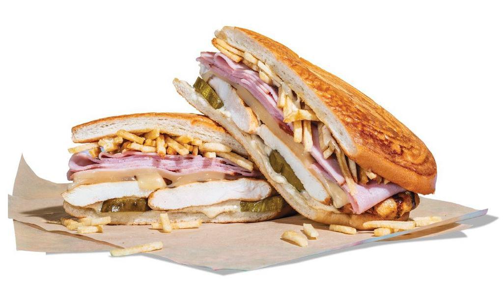 The Grilled Chicken Cuban · Grilled chicken breast and sliced ham served on a Cuban roll with Gouda cheese, potato sticks, pickles and a creamy mustard spread.