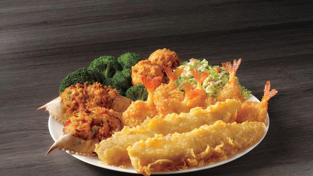 Deluxe Seafood Platter · For those seeking seafood variety, we combine two fish fillets, six shrimp, two seafood stuffed crab shells with your choice of two sides and hush puppies.