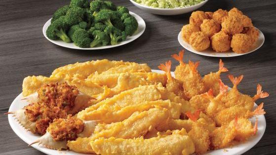 Seafood Feast · Twelve pieces of our famous batter dipped fish, twelve crispy butterfly shrimp, three seafood stuffed crab shells, twelve hush puppies and your choice of two family-style sides.