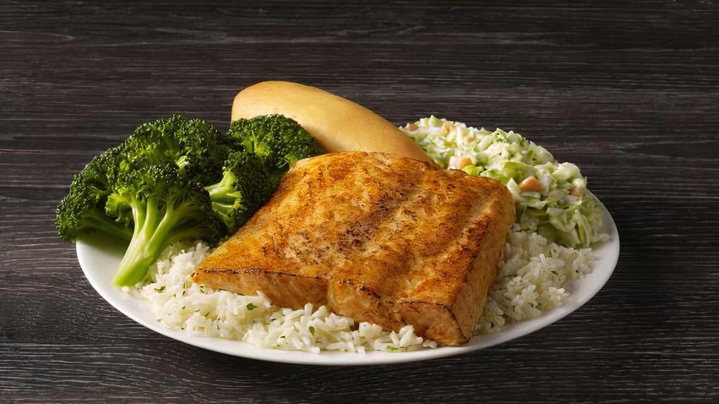 Wild Alaskan Salmon Meal · Wild Alaskan Salmon seared to perfection and served on a bed of rice with your choice of two sides and a breadstick.