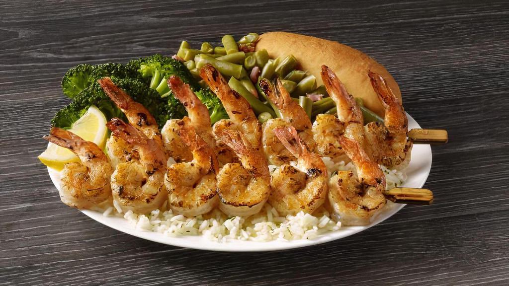 Shrimp Skewers Meal · Plump seasoned shrimp that are seared to perfection and served on a bed of rice with your choice of two sides and a breadstick.