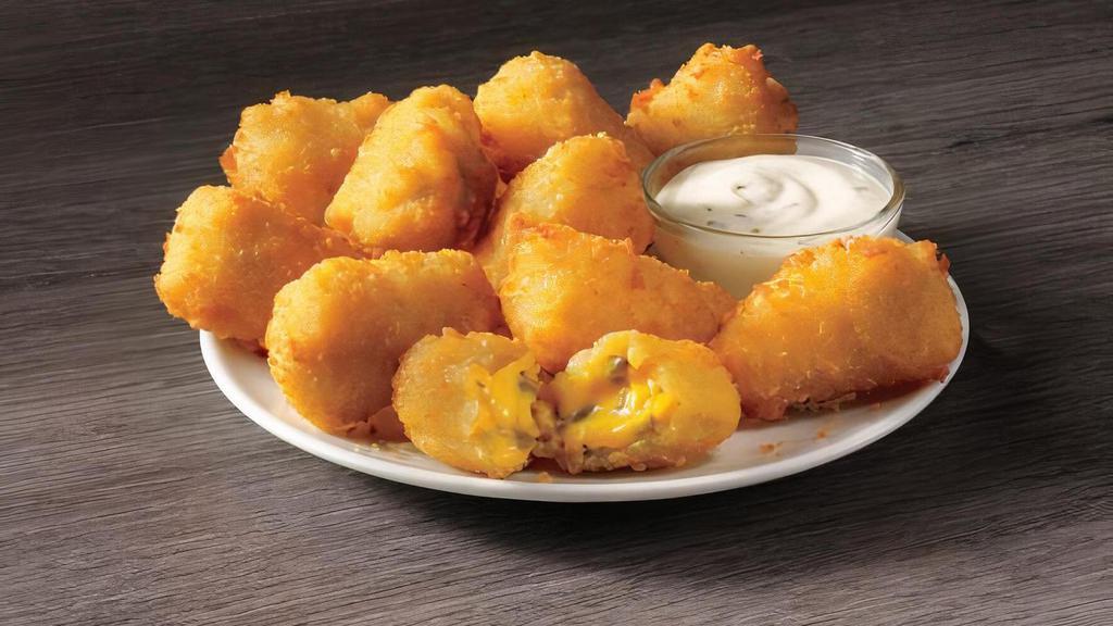 Jalapeño Poppers · Golden fried jalapeños and cheese that’s just begging to be dipped in ranch, will start your meal with a kick.