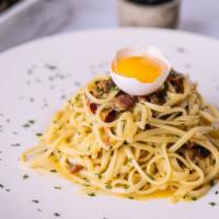 Spaghetti Carbonara · Yolk eggs, parsley, bacon and parmesan cheese.