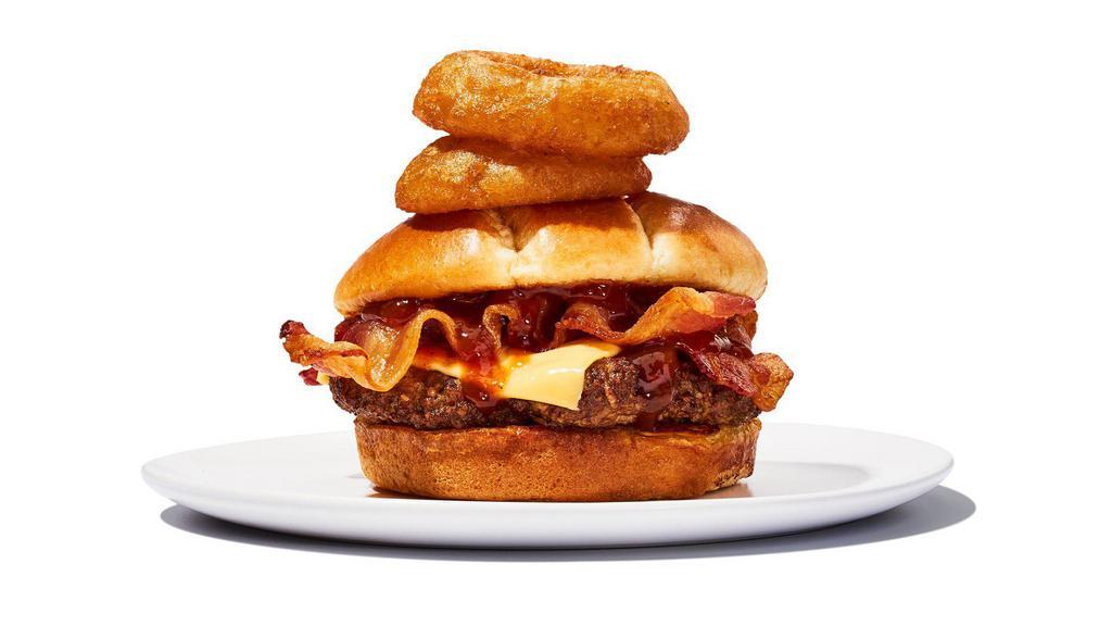 Western Bbq Burger · Two 4oz Patties, BBQ sauce, melted Cheddar, bacon and onion rings all wrangled into a toasted brioche bun. Includes choice of fries.