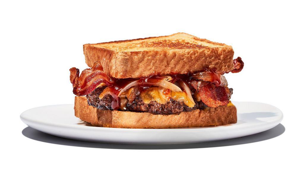 Twisted Texas Melt · Yippee Kai Yay, hungry trucker. Two 4oz Patties meets caramelized onions, bacon and cheddar cheese, fully loaded with a layer of our Daytona Beach sauce and served on Texas Toast. Includes choice of fries.