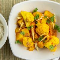 Aloo Gobi · Fresh cauliflower and potato cooked with tomato and spices.