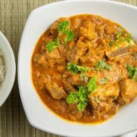 Goat Curry · Bone-in goat sauteed with onion, tomato and blend of spices cooked in a mild sauce.