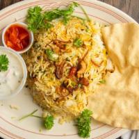 Chicken Dum Biryani · Long grain basmati rice flavored with saffron and cooked with a delicate blend of exotic spi...