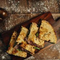 Prosciutto E Mozzarella
 · Home-made bread, prosciutto di parma, and mozzarella.