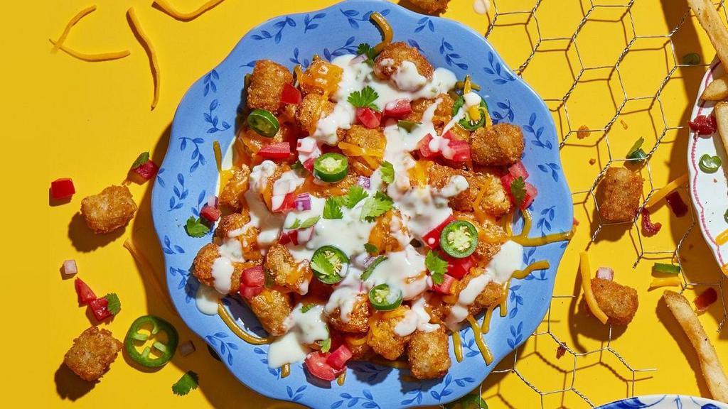 Nacho Tots · Say ole with shredded cheddar, pico de gallo, sliced jalapenos and a side of rich queso.