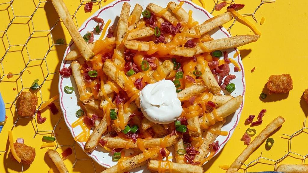 Loaded Fries · Get 'em loaded with cheddar cheese, sour cream, bacon and green onions.