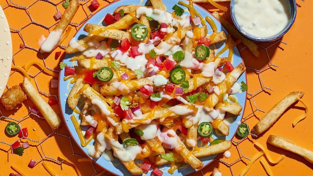 Nacho Fries · Say ole with shredded cheddar, pico de gallo, sliced jalapenos and a side of rich queso.