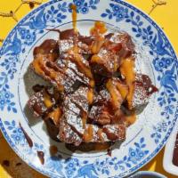 Brownie Bites · Ooey, gooey and all sauced up. Enjoy this decadent walnut brownie with caramel sauce and cho...