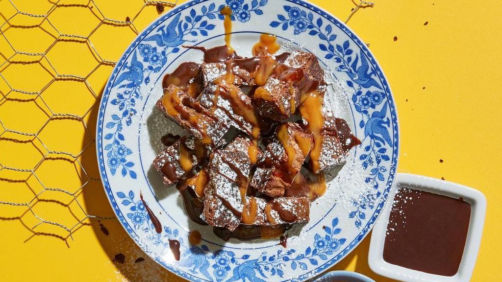 Brownie Bites · Ooey, gooey and all sauced up. Enjoy this decadent walnut brownie with caramel sauce and chocolate syrup. .