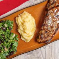 Ribeye Steak (12 Oz) · Mashed potatoes and kale salad.