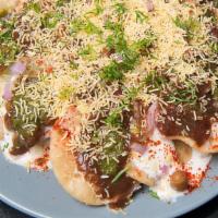 Papdi Chat · Fried Chips in chickpea gravy. Covered in tamarind sauce mint sauce, yogurt, and spices