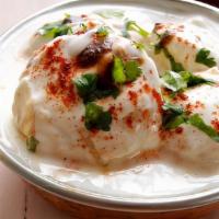 Dahi Vada · Fried Vada soaked in yogurt. Topped with tamarind sauce, mint sauce, yogurt, and spices