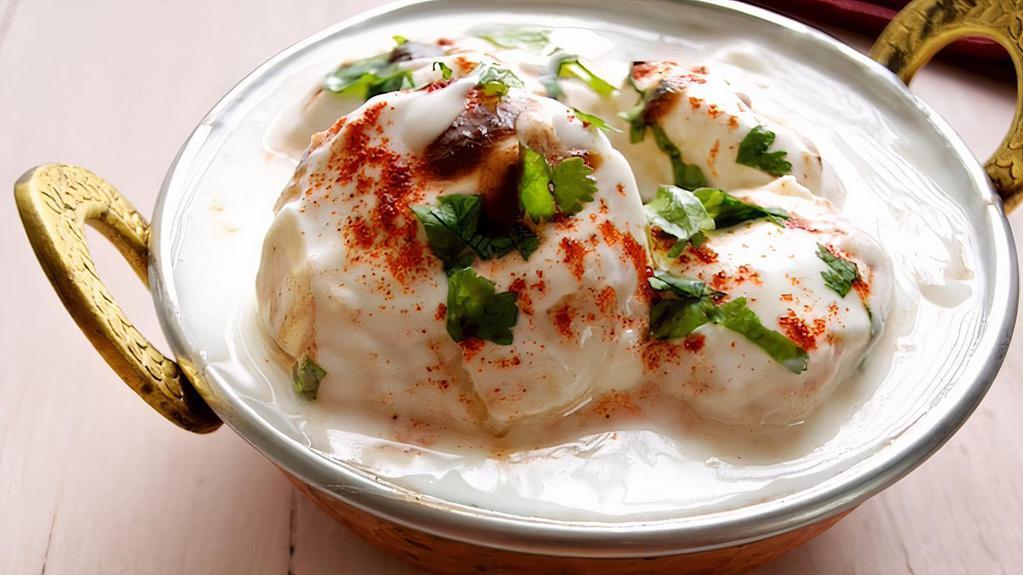 Dahi Vada · Fried Vada soaked in yogurt. Topped with tamarind sauce, mint sauce, yogurt, and spices
