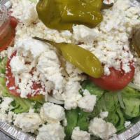 Greek Salad · Mixed romaine, iceberg lettuce, red onions, black olives, feta cheese, cucumbers, and tomato...