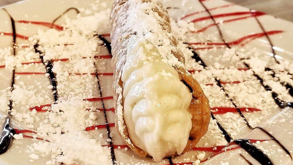 Fresh Cannoli · A flaky cannoli shell filled with creamy ricotta cheese flavored with tangy bits of orange.