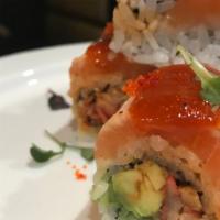 Crazy King Crab Roll · Spicy king crab, almonds, and avocado, topped with seared salmon, garlic pesto oil, hot chil...