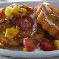 Rum Cake French Toast · French-toast style spiced rum cake with pecans. Topped with grilled fresh pineapple, fresh b...
