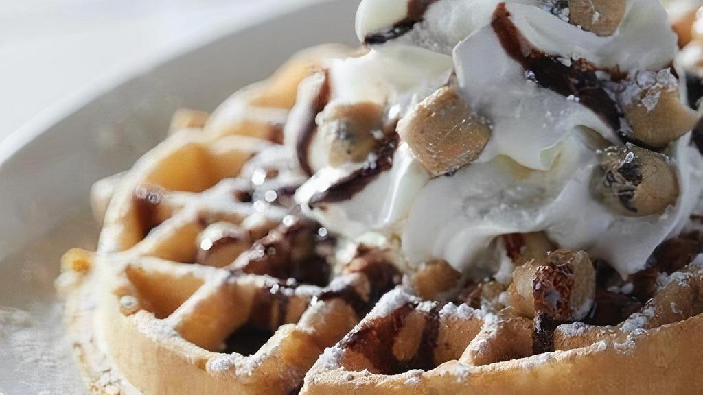 Cookie Dough Waffle  · Freshly-baked cookie dough Belgian waffle topped with even more cookied dough, fresh whipped cream, chocolate drizzle and powdered sugar. Served with two eggs any style (add 120 - 220 cal) and baked bacon or house-made sausage patties (add 180/250 cal).