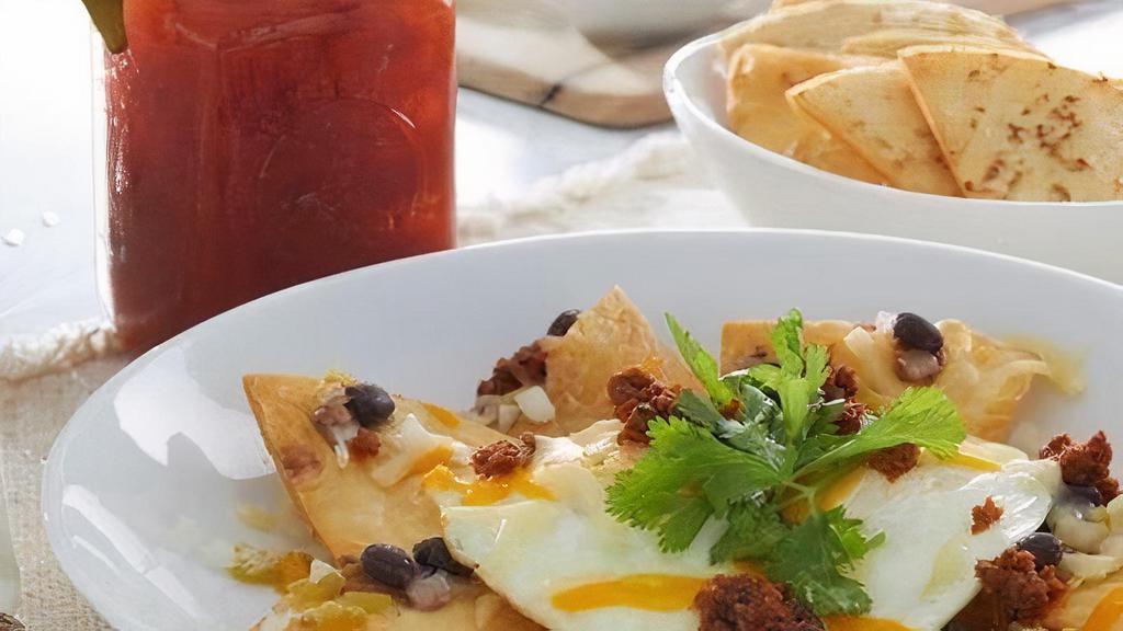 Huevos Rancheros · Crispy flour tortillas, black beans, green chilies, onions and two over-medium eggs with Cheddar Jack cheese and cilantro.  Sides of salsa and sour cream.