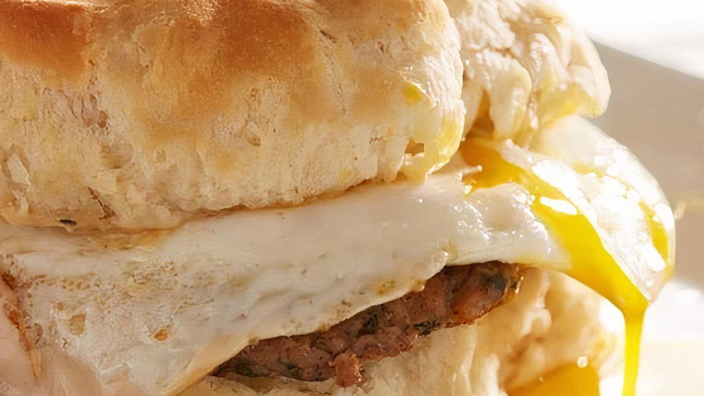 Broken Egg® Biscuit Sandwich · Fried chicken tender and a BROKEN EGG® topped with country sausage gravy on an over-sized biscuit.