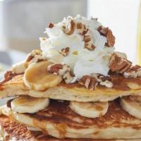 Bourbon Street Pancakes · Three house-recipe cakes topped bananas, pecans, rum butter sauce drizzle and whipped cream.