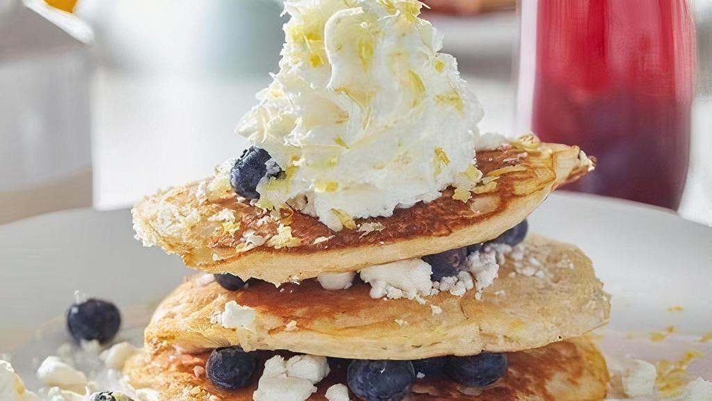 Lemon Blueberry Goat Cheese Pancakes  · Three house-recipe cakes with fresh blueberries and goat cheese, topped with lemon zest and fresh whipped cream.