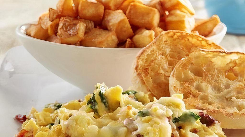 Sunrise Spinach Scrambler · Scrambled eggs filled with fresh spinach, bacon and onions, topped with Jack cheese.