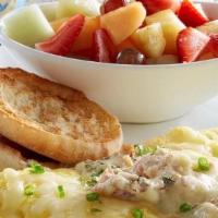 The Floridian™ Omelette · Cream cheese-filled omelette topped with garlic butter sautéed crab meat, Jack cheese and gr...