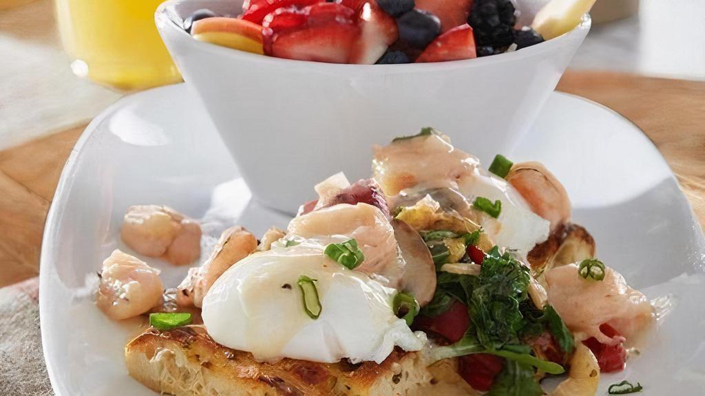 Skinny Shrimp Benedict · Poached eggs on grilled focaccia with sautéed mushrooms, roasted peppers, onions and arugula.  Topped with Gulf shrimp in a creamy velouté sauce and sliced green onions. Served with fresh seasonal fruit.