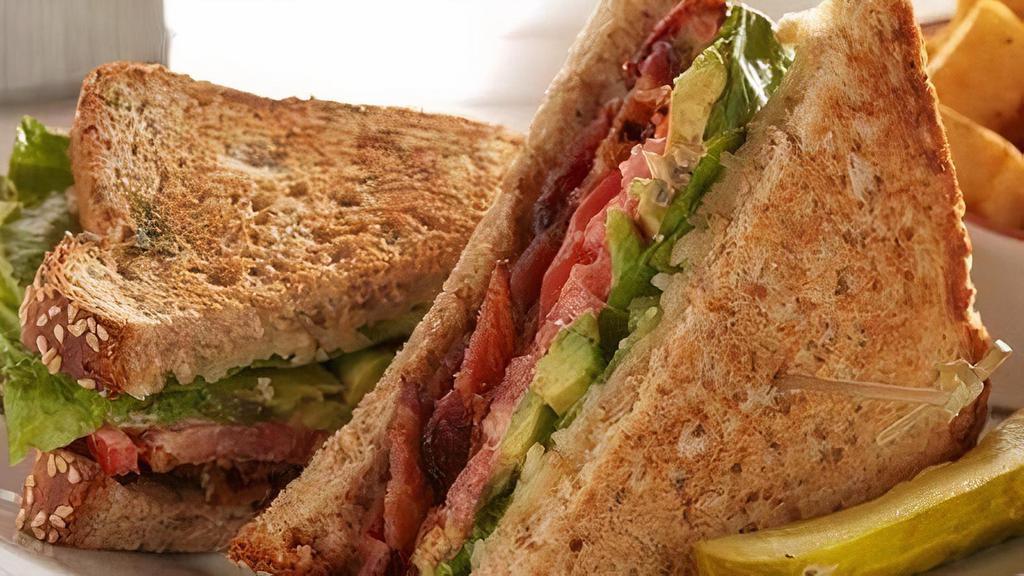Bacon Lover'S Blt&A · Thick-cut baked bacon strips, lettuce, avocado, tomatoes and Cheddar Jack cheese with garlic aioli. Substitute gluten-friendly bread for nine-rain bread. Served with pickle and grits.