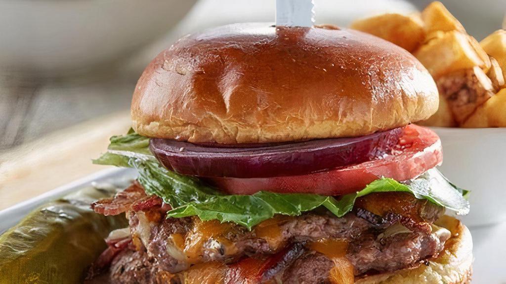Classic Bacon Burger - Gluten Friendly · Two hand-pressed beef patties, baked bacon, Cheddar Jack cheese, lettuce, tomato and red onion on. Substitute gluten friendly bread for brioche bun. Served with a pickle and grits.