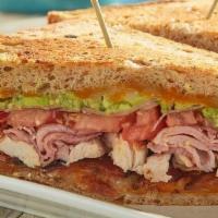 Sonoma Club Sandwich · Ham, turkey, baked bacon, guacamole, Cheddar Jack cheese, tomato and pickled red onions on y...